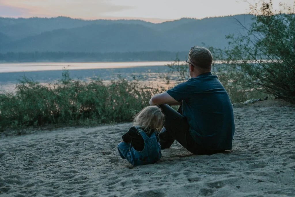 man and child on beach