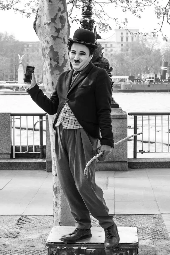 Grayscale Photo of Man Holding Smartphone