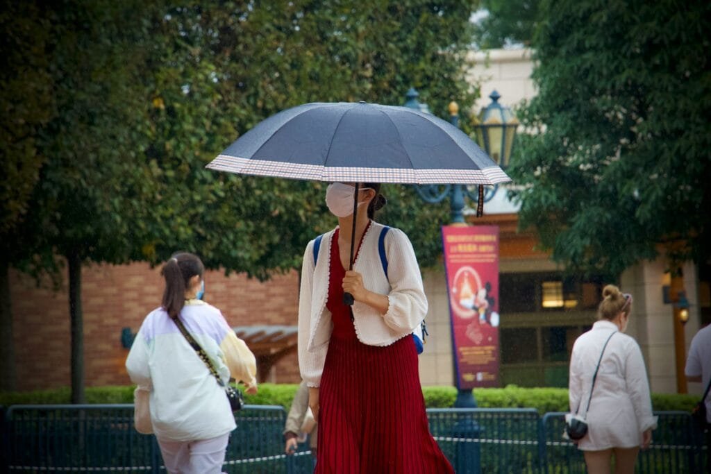 a person in a red dress holding an umbrella