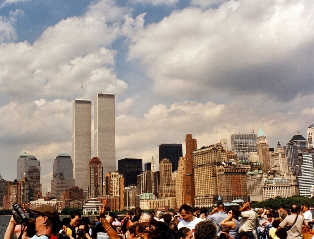 a crowd of people in front of a city skyline