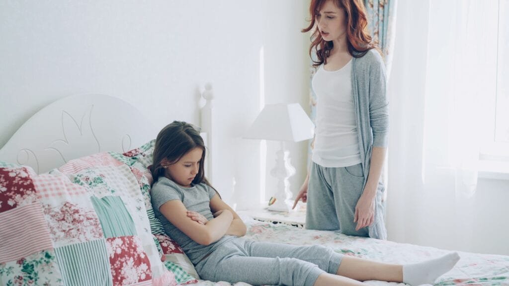 A mother confronts her child, who is upset.