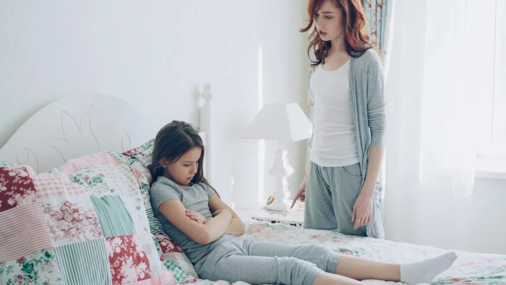 A mother confronts her child, who is upset.