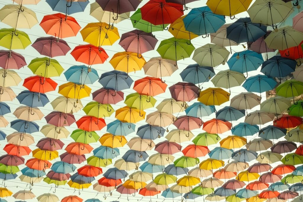 a bunch of umbrellas hanging from the ceiling