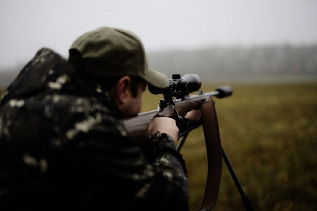 A man with a rifle in a field